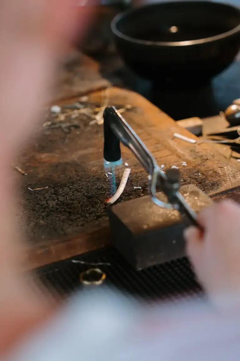 Torch soldering a silver ring during a Bali jewelry workshop